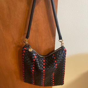 Clare V fold over clutch with tubular strap.